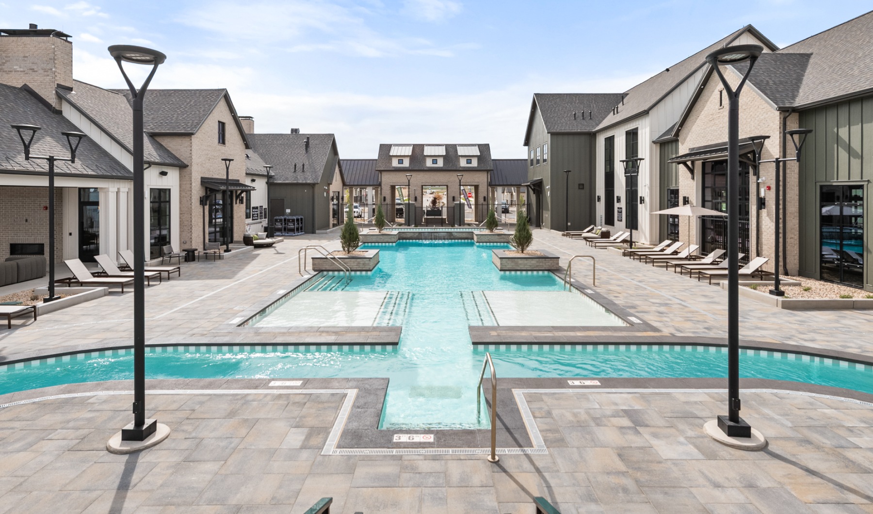 Apartment community swimming pool with sun shelves and outdoor seating in Saratoga Springs, Utah