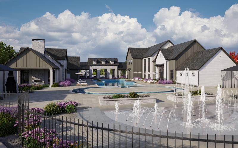 a fountain in front of a group of white buildings