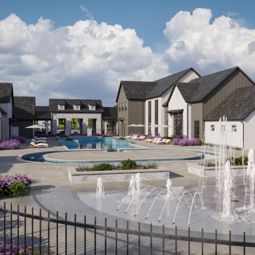 a fountain in front of a group of white buildings